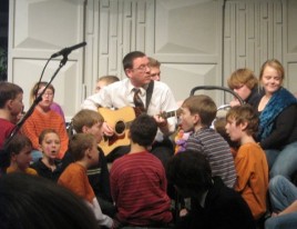 Jamie Soles singing along with a group of kids